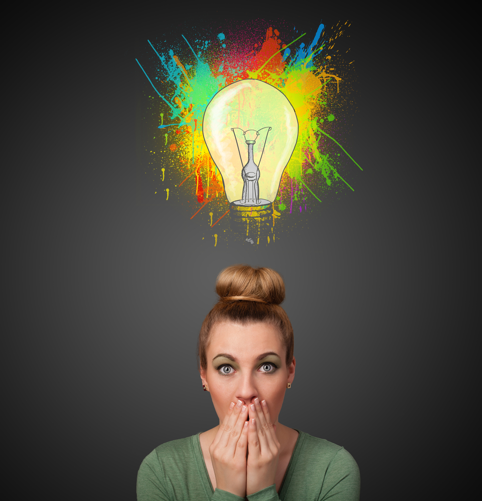 Young woman thinking with lightbulb above her head